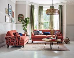 DFS Joules Patterdale four-seater sofa in plain coral velvet and cuddler in navy and coral pattern velvet