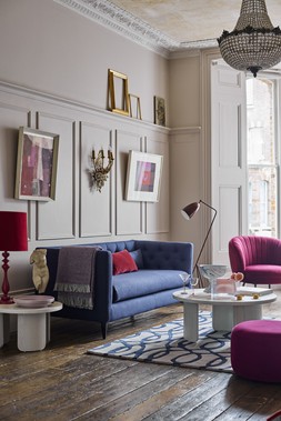 DFS Mya Three-Seater Sofa in Simply Wool Look in Indigo Blue, Joules Langton Small Round Plain Footstool in Red Plum Velvet, available exclusively at DFS, Dwell Kelda Accent Chair in Red Wine Velvet, available at DFS, Dwell Becc Nesting Coffee Tables, available at DFS
