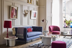 DFS Mya Three-Seater Sofa in Simply Wool Look in Indigo Blue, Dwell Kelda Accent Chair in Red Wine Velvet, available at DFS, Dwell Becc Nesting Coffee Tables, available at DFS, Swoon Aero Bar Trolley, available at DFS