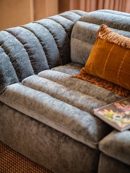 Olson 2.5 Seater in Luxury Textured Chenille Lagoon with Double Power Recliner and Double Power Headrest, £1499. Olson Designer Footstool in Luxury Textured Chenille Brick, £449.