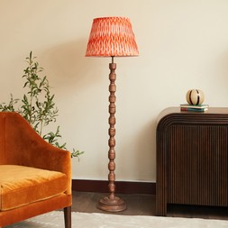 Wood floor lamp with orange pleated shade
