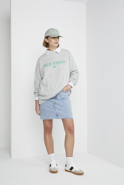 Sage Green Cap &pound;8, Oversized Grey Palm Springs Sweatshirt &pound;16, Blue Denim Mini Skirt &pound;16, White Retro Trainers &pound;18